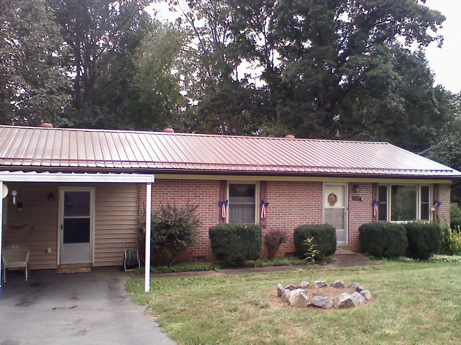 Bronze metal roof and carport on a brick ranch home — Roof Repair work by our crew in Ringtown